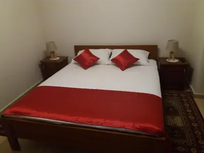 a bedroom with a bed with red pillows on it at BNB Njeguska sijela in Njeguši