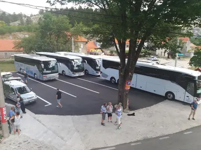 a group of buses parked in a parking lot at BNB Njeguska sijela in Njeguši