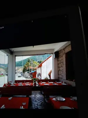 a room with tables and chairs and a large window at BNB Njeguska sijela in Njeguši