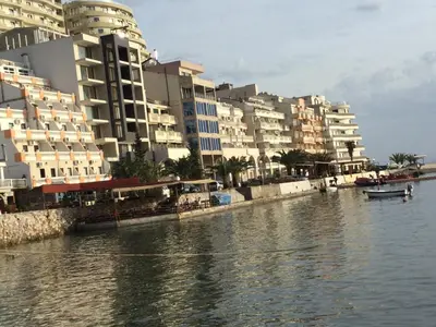 a group of buildings next to a body of water at Apartment Sunset in Rafailovici