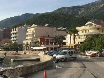 a group of cars parked in a parking lot at Apartment Sunset in Rafailovici