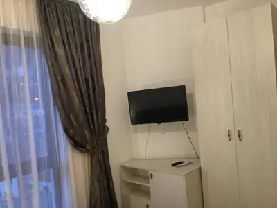 a small room with a television and a window at Apartment Sunset in Rafailovici