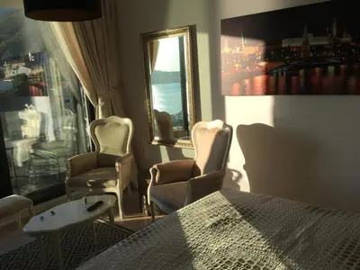 a room with chairs and a table and a window at Apartment Sunset in Rafailovici