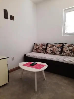 a living room with a couch and a table at Apartmani na moru in Bar