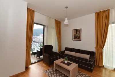 a living room with a couch and a table at Lux Apartments Kristina in Budva