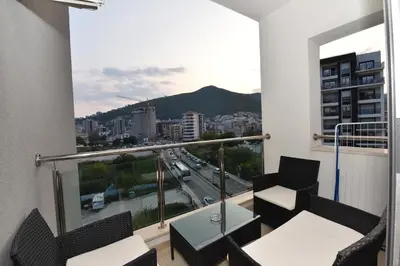 a balcony with chairs and a view of a city at Lux Apartments Kristina in Budva