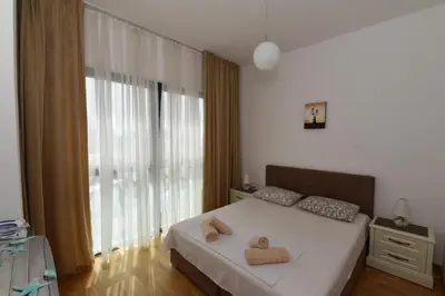 a bedroom with a bed with two towels on it at Lux Apartments Kristina in Budva