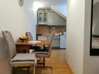 a kitchen with a table and chairs in a room at Apartment Vukasevic in Virpazar