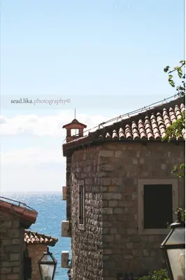 a brick building with the ocean in the background at Sunset Old Town in Ulcinj