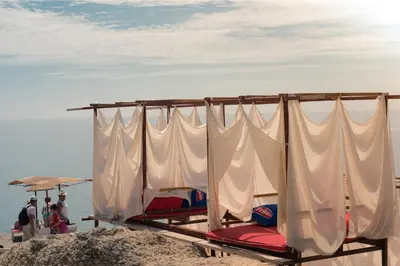 a group of beds sitting on the beach at Sunset Old Town in Ulcinj