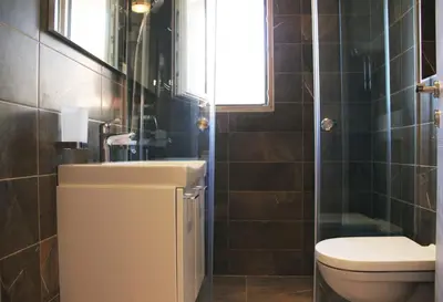 a bathroom with a toilet and a sink at Vasiliki Seaside Apartments in Petrovac na Moru