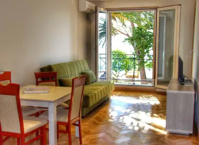 a living room with a couch and a table at Vasiliki Seaside Apartments in Petrovac na Moru