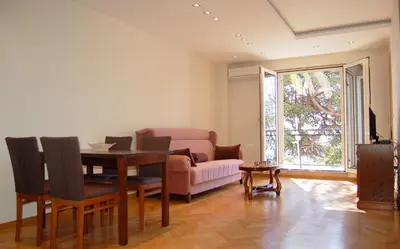 a living room with a table and a couch at Vasiliki Seaside Apartments in Petrovac na Moru
