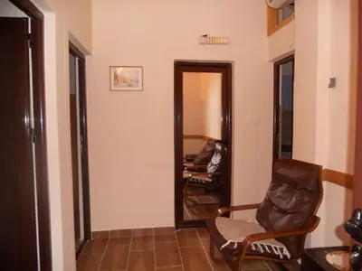 a living room with a chair and a mirror at Apartment Stana in Petrovac na Moru