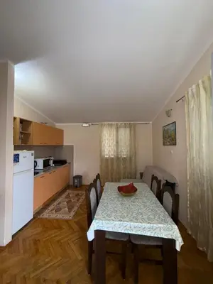 a kitchen and dining room with a table and chairs at Apartment Stana in Petrovac na Moru