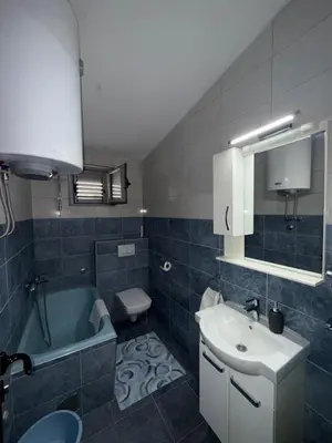 a bathroom with a sink and a toilet and a tub at Apartment Stana in Petrovac na Moru
