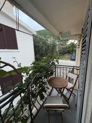 a balcony with a table and a chair and a table at Apartment Stana in Petrovac na Moru