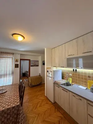 a kitchen with a table and a counter top at Apartment Stana in Petrovac na Moru