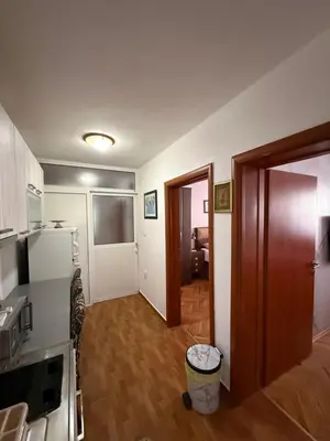 a room with a kitchen and a hallway with a door at Apartment Stana in Petrovac na Moru