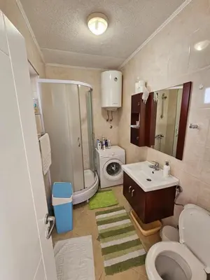 a bathroom with a toilet sink and a washing machine at Apartment Ralf in Ulcinj