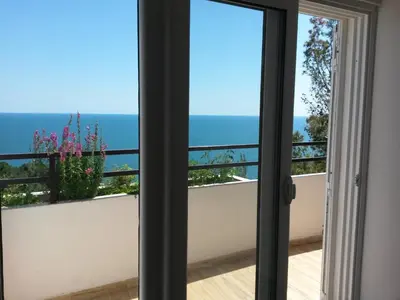 a room with a view of the ocean from a balcony at Apartment Ralf in Ulcinj