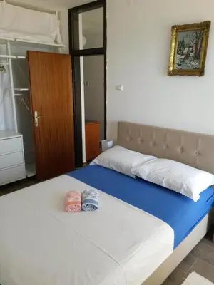 a bedroom with a bed with two towels on it at Apartment Ralf in Ulcinj