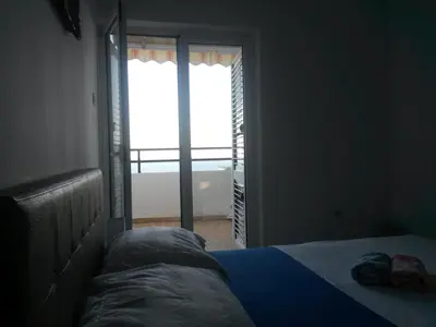a bedroom with a bed and a large window at Apartment Ralf in Ulcinj
