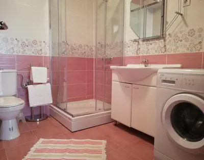 a bathroom with a washing machine and a sink at Apart Forte Roses Montenegro KO Buljarica in Petrovac na Moru