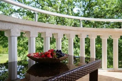 a bowl of fruit sitting on a table on a porch at Apart Forte Roses Montenegro KO Buljarica in Petrovac na Moru