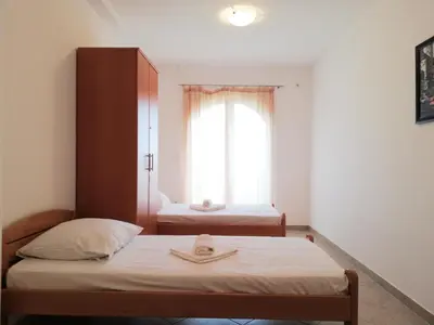 a small room with two beds and a window at Apart Forte Roses Montenegro KO Buljarica in Petrovac na Moru