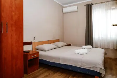 a bedroom with two beds and a window at Apartments Djukic in Tivat