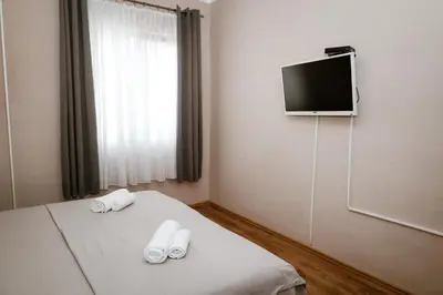 a hotel room with a bed with towels on it at Apartments Djukic in Tivat