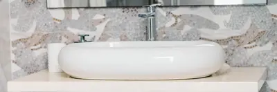 a white sink sitting on a counter in a bathroom at Apartments Antique in Ulcinj