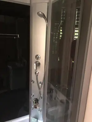 a glass shower door with a shower head at Apartments Qualitas in Kotor