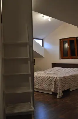 a bedroom with a bed and a book shelf at Apartments Qualitas in Kotor