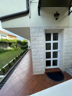 a patio with a door and a yard at Apartment Garden in Kotor