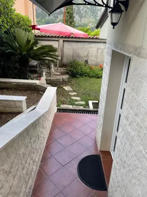 a walkway leading into a yard with a patio at Apartment Garden in Kotor