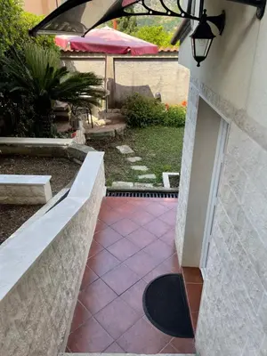 a walkway leading to a patio in a yard at Apartment Garden in Kotor