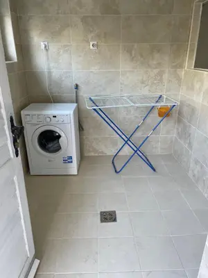 a bathroom with a washing machine and a washer at Apartment Garden in Kotor