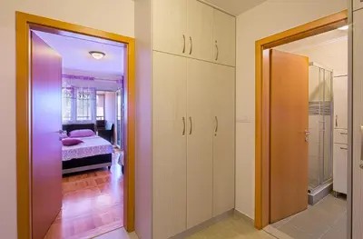 a room with a bedroom with a bed and a mirror at Apartment SVS in Budva