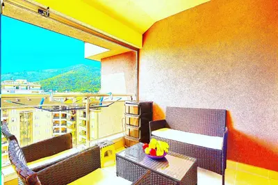 a balcony with a table and a view of a city at Apartment SVS in Budva