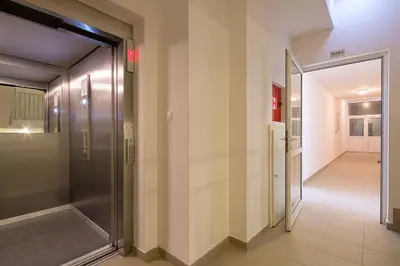 a hallway with a glass door and a hallway leading to a hallway at Apartment SVS in Budva
