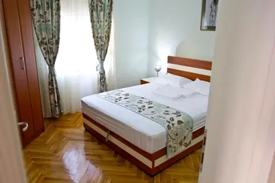 a bedroom with a bed and a window at Apartments Gran Sasso in Ulcinj