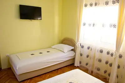 a small room with a bed and a window at Apartments Gran Sasso in Ulcinj