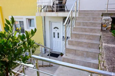 a set of stairs leading to a white door at Apartments Gran Sasso in Ulcinj
