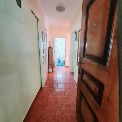 a hallway with a wooden door and a tile floor at Ivan's Holiday Home in Virpazar