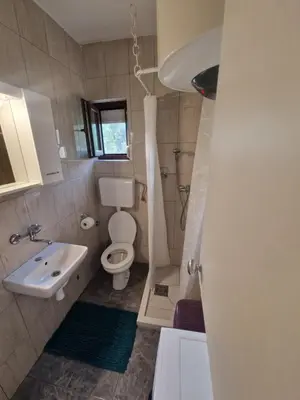 a bathroom with a toilet and a sink at Ivan's Holiday Home in Virpazar