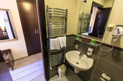 a bathroom with a sink and a mirror at Lucic Rooms & Suites in Budva