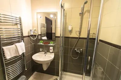 a bathroom with a sink and a shower at Lucic Rooms & Suites in Budva