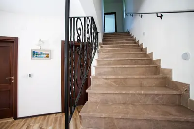 a staircase in a home with a stair railing at Rosmarino in Sveti Stefan